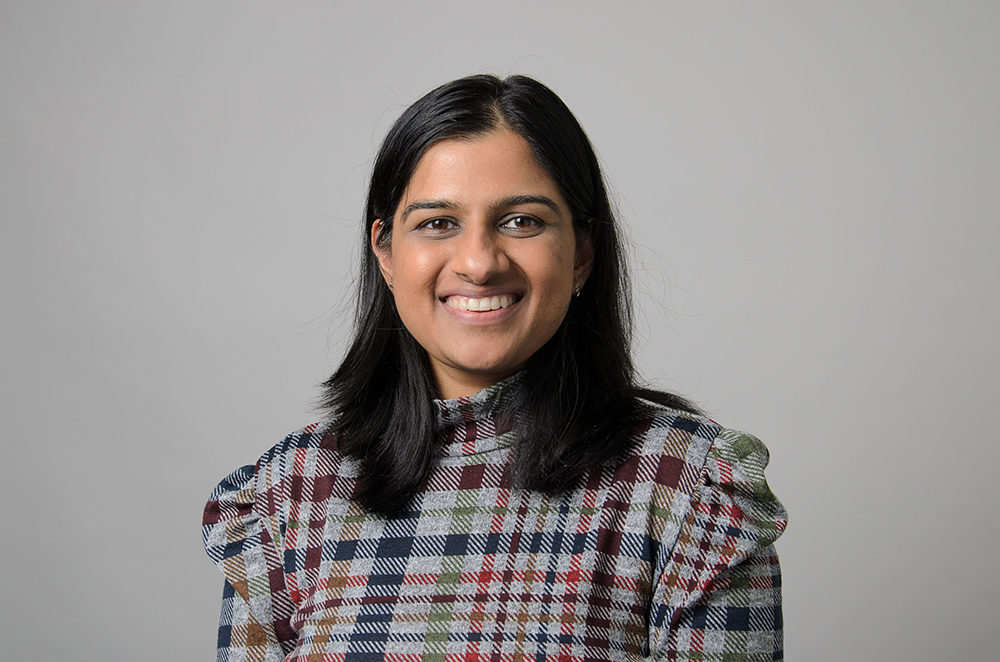 Portrait of Kriti Bhargava wearing a plaid blouse with ruffles.