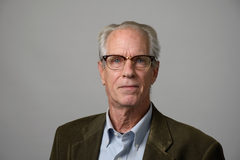 Portrait of Robert Macieski wearing a brown corduroy blazer and blue collared shirt.